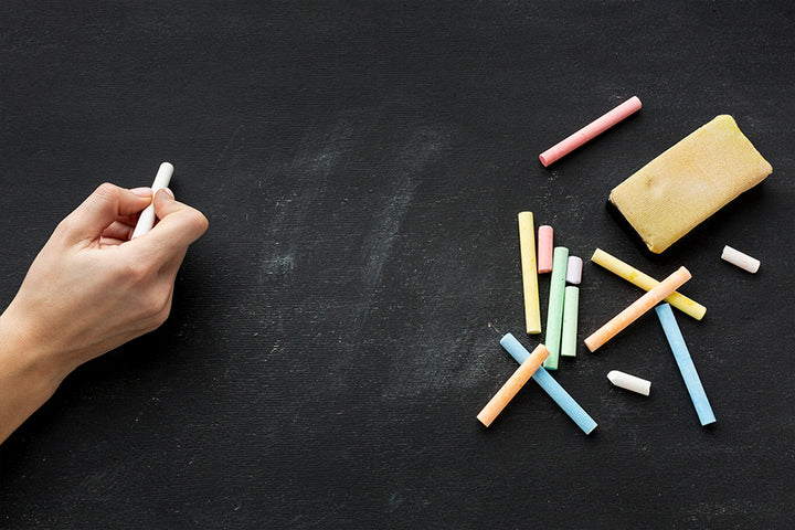 Hand holding chalks | slate pencil-eating benefits
