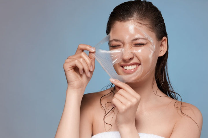a woman removing skin peeling mask from her face