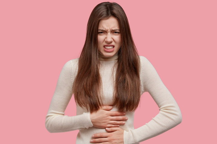 a woman suffering from stomach pain due to constipation
