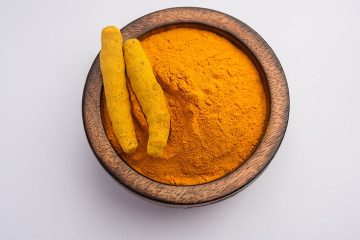 a bowl of turmeric powder for skin