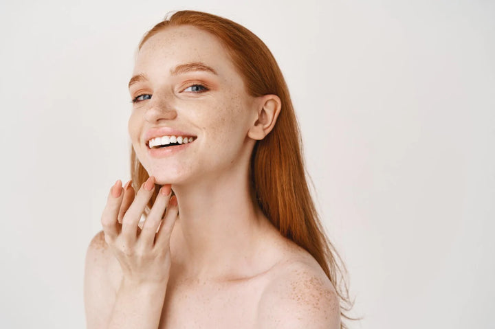 A woman smiling and showing her radiant skin | pale skin tone