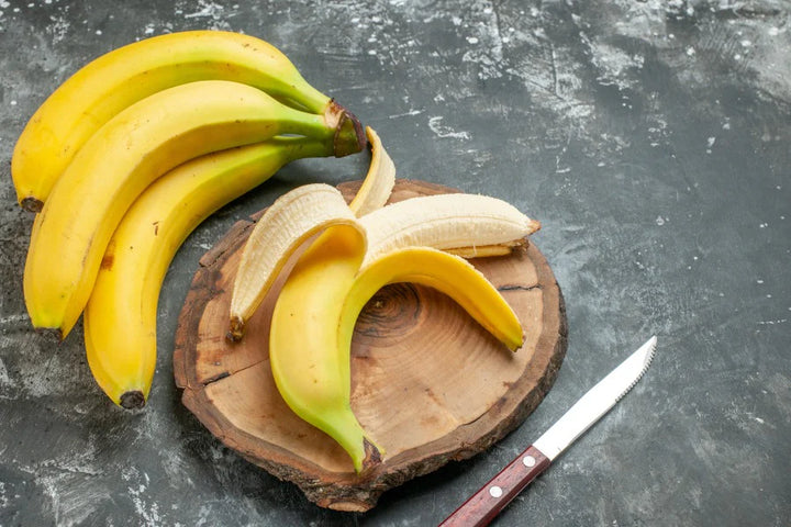 Bananas and peeled banana, knife | benefits of eating banana