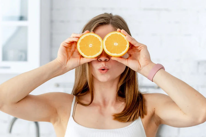 woman showing orange | Best and Nutritious fruits for glowing skin