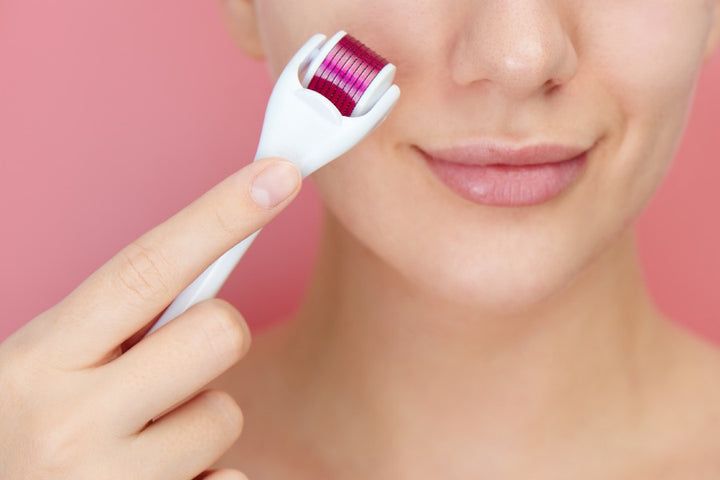 woman using derma roller on the face