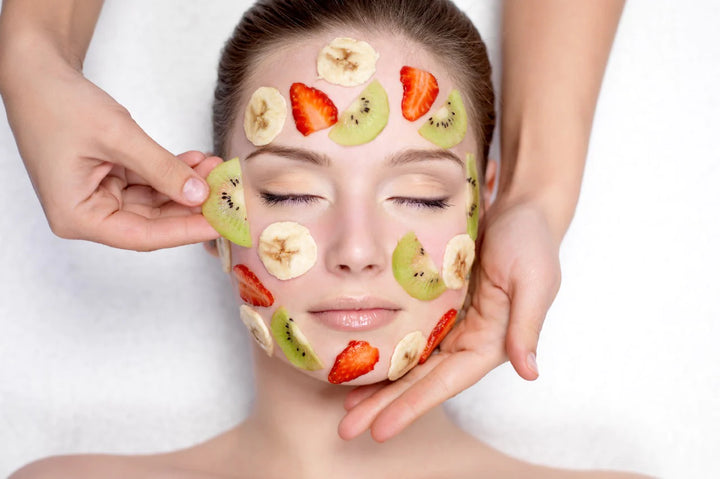 A woman applying fruits on her face | fruit facial benefits