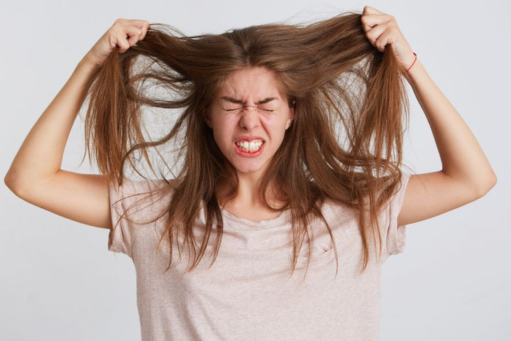 a woman pulling her hair | Hair Pulling Disorder