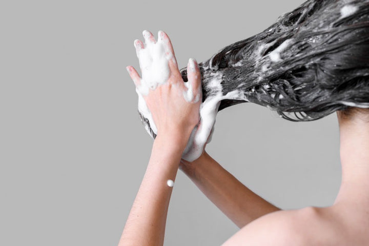 a woman shampooing her hair | How Can Women Maintain Their Hair Hygiene