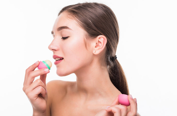 women applying lip balm | exfoliator for lips homemade