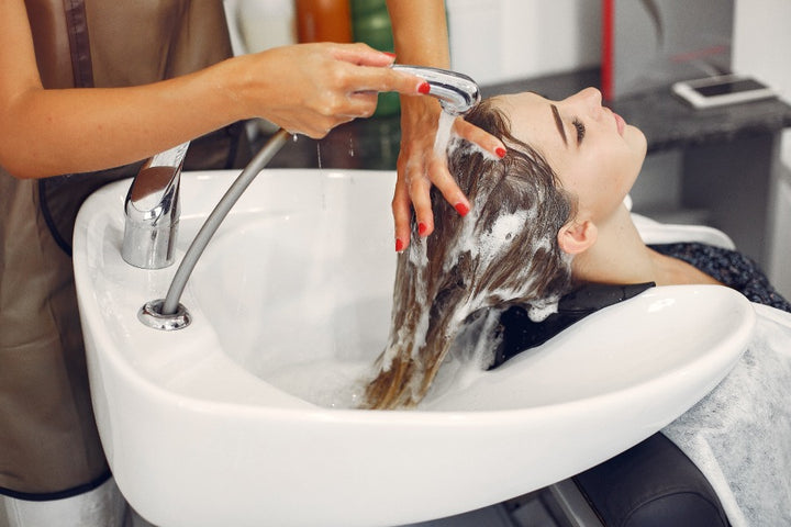 a woman shampooing her hair | How to Manage Hair After Keratin Treatment