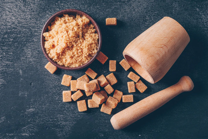 jaggery cubes, jaggery powder in bowl and mortal pestle | jaggery and its benefits