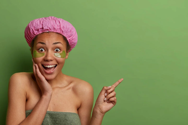 A woman smiling and pointing out something | how to reduce dark circles