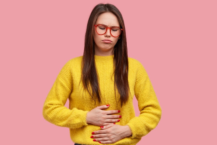 a woman suffering from stomach inflammation