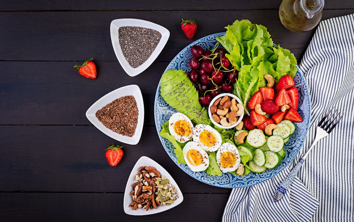 A large plate containing healthy foods like fruits and green leafy vegetables
