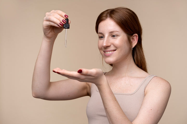 a woman applying face serum