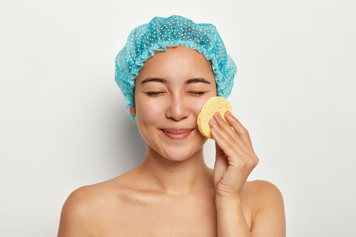 a woman exfoliating her face