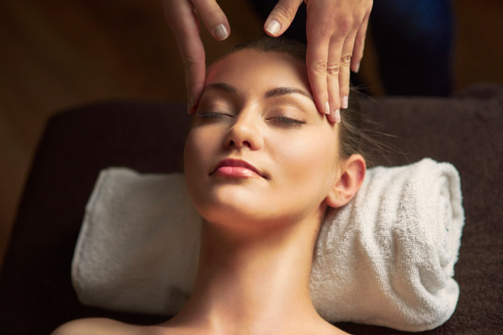 a woman is enjoying head massage
