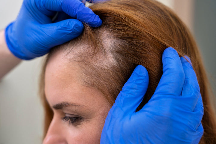 a doctor examining a woman's scalp
