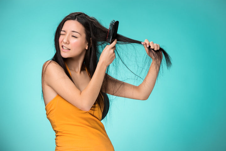 a woman combing her hair