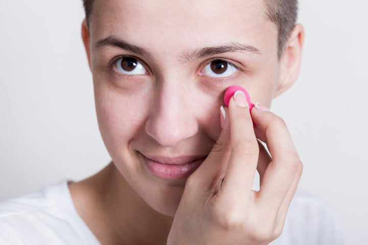 a woman applying under eye cream