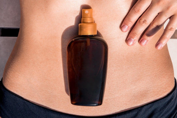 a slimming oil is kept on a woman's belly