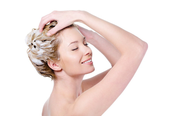 a woman using ketoconazole shampoo