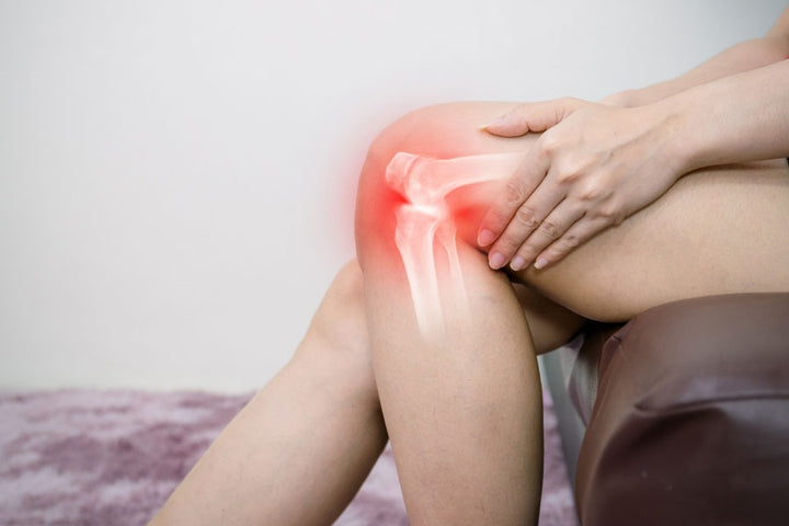 a woman holding her knee | Which Arthritis is Worse in Summer