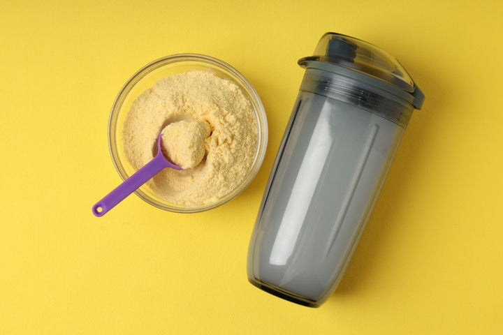 a bottle of water and a bowl of protein powder | Why You Must Consider Taking Weight Loss Powder Along with Your Workouts