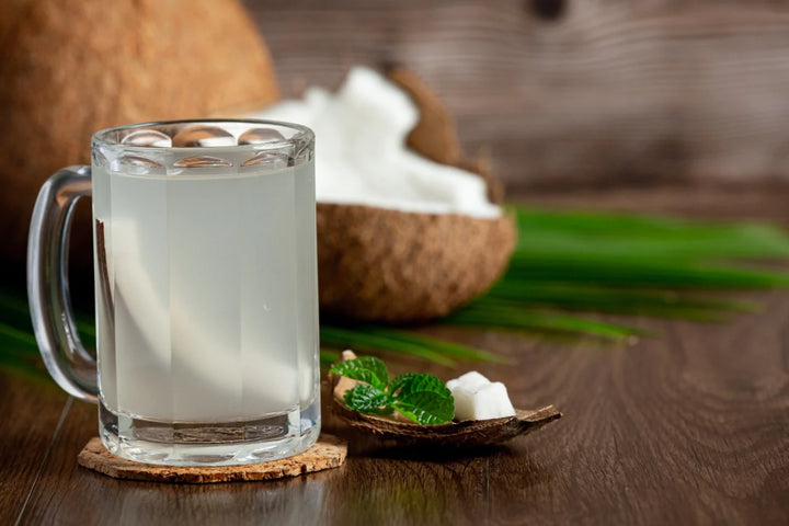 Coconut and a cup of coconut water | benefits of coconut water for skin